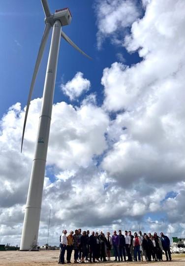 Delegation members in front of a 150-meter turbine at the Østerild Test Centre, a state-owned facility that allows companies to test the latest offshore wind technologies