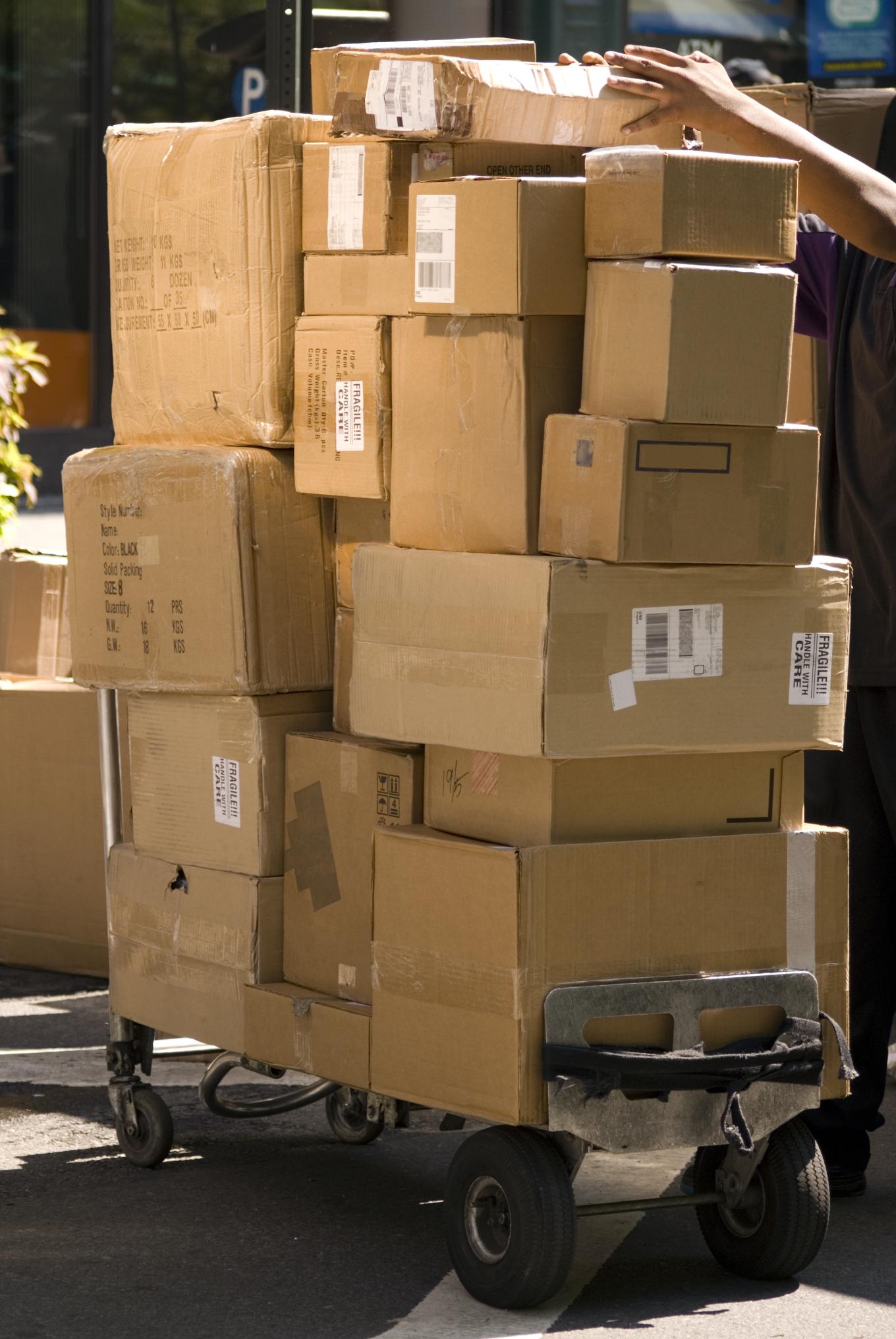 Hand truck with towering number of parcels for delivery