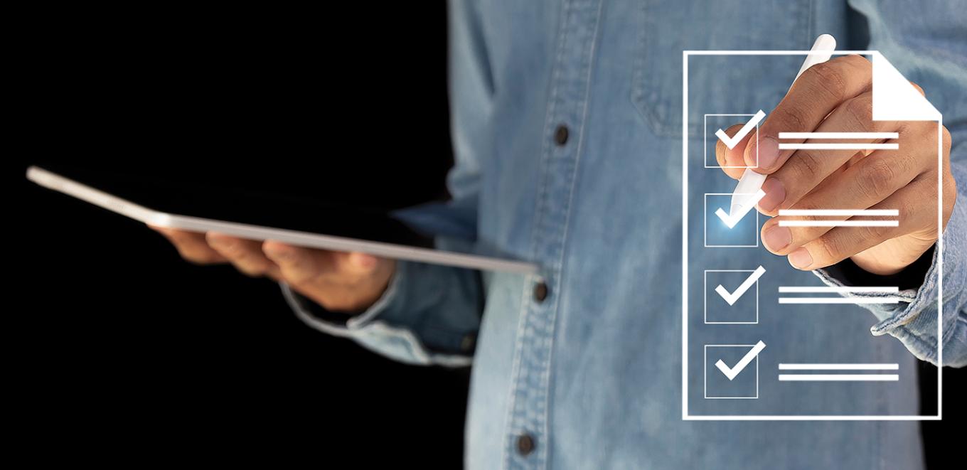 person holding a laptop next to an illustration of a clip board with boxes to check off