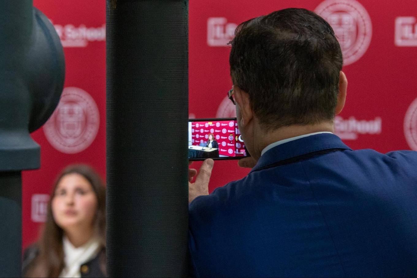 Audience member taking shot of high road final presentation 