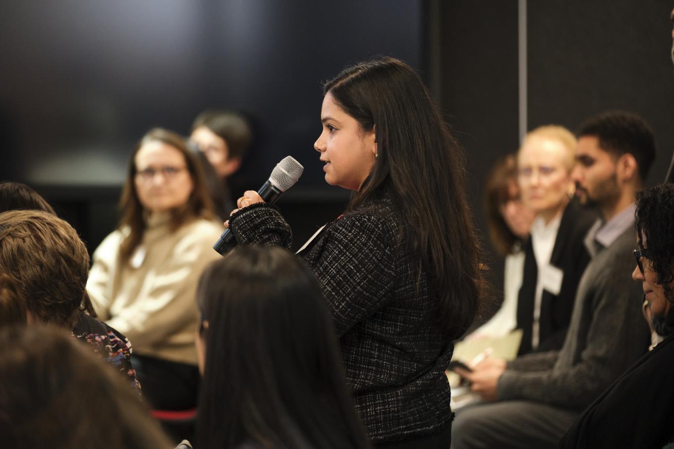 A woman asks a question to a panel discussion at the 2025 GLI Conference in New York City