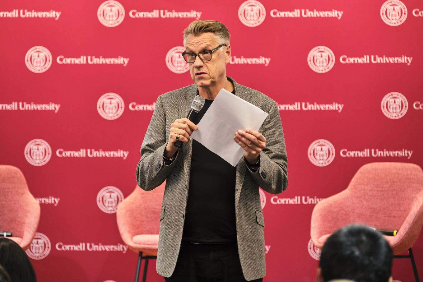 Colin Browne stands at a podium at the 2025 Global Labor Institute conference in New York City, standing in front of a backdrop that says Cornell University.