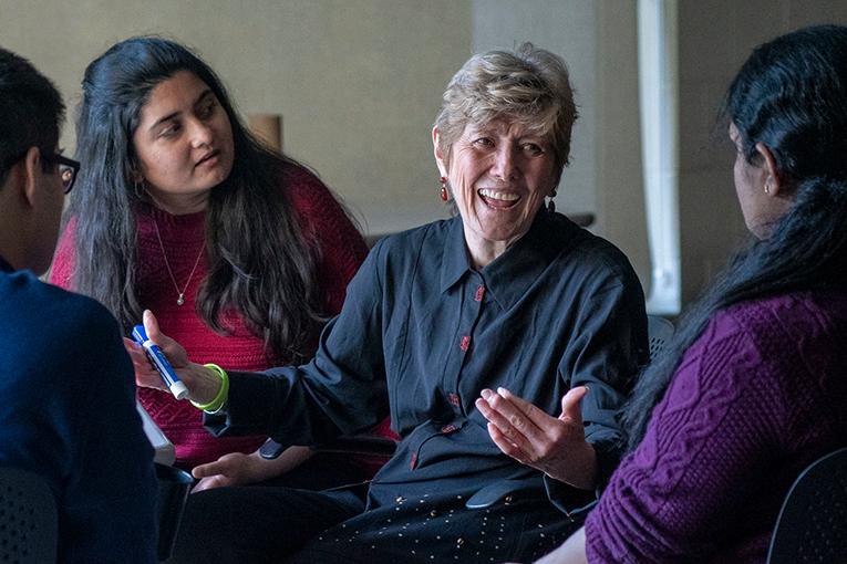 Professor Rosemary Batt talking with students in the classroom.