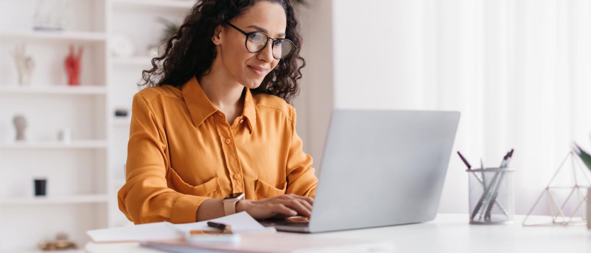 Woman looking at laptop.
