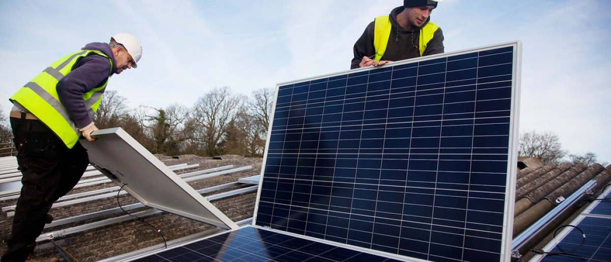 Solar workers installing panels