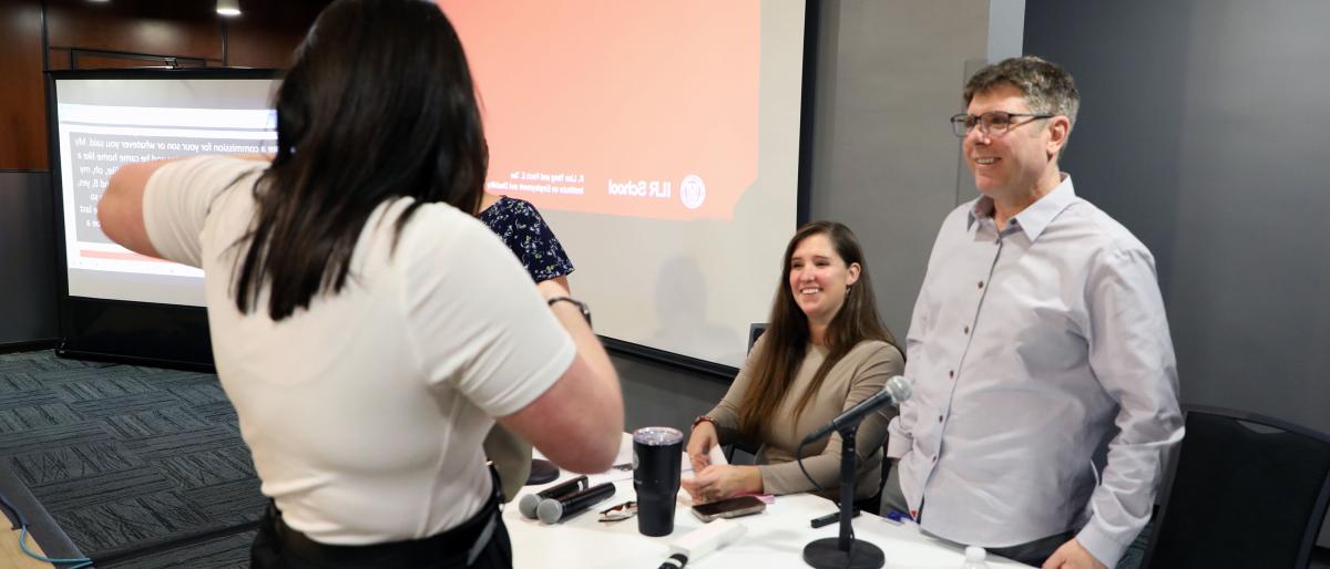 two YTI staff members speaking with DREAM event attendees