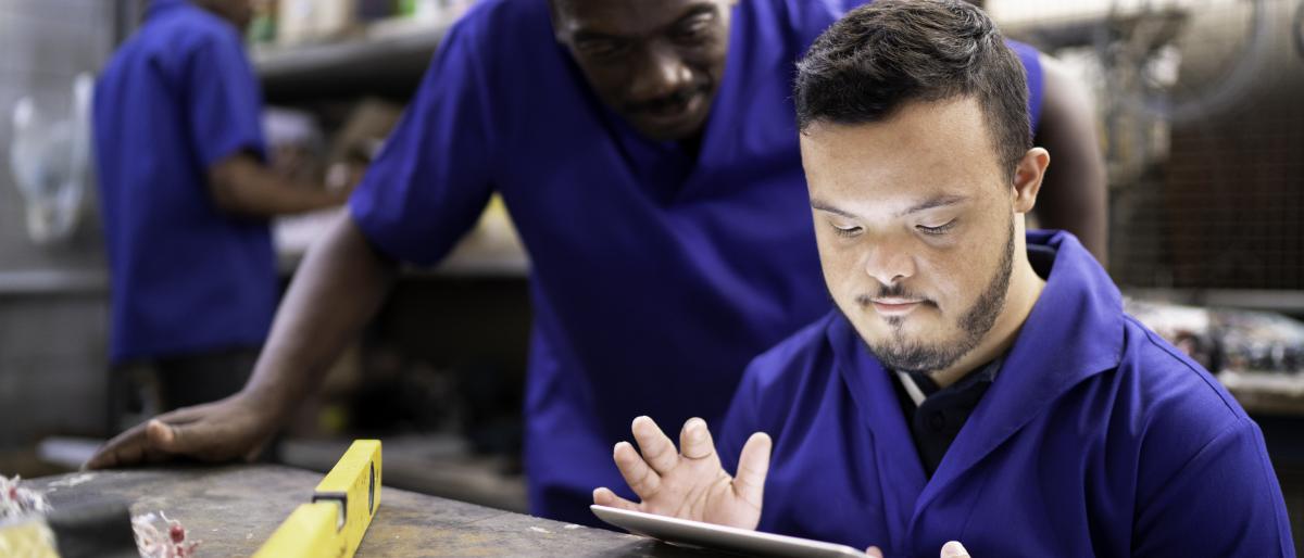 Colleagues using digital tablet and working in industry