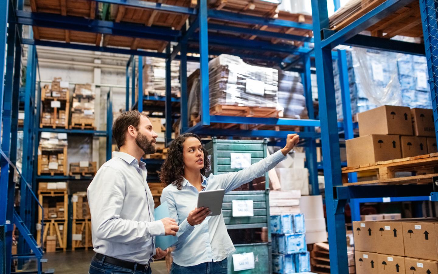 Manager working with foreman in warehouse