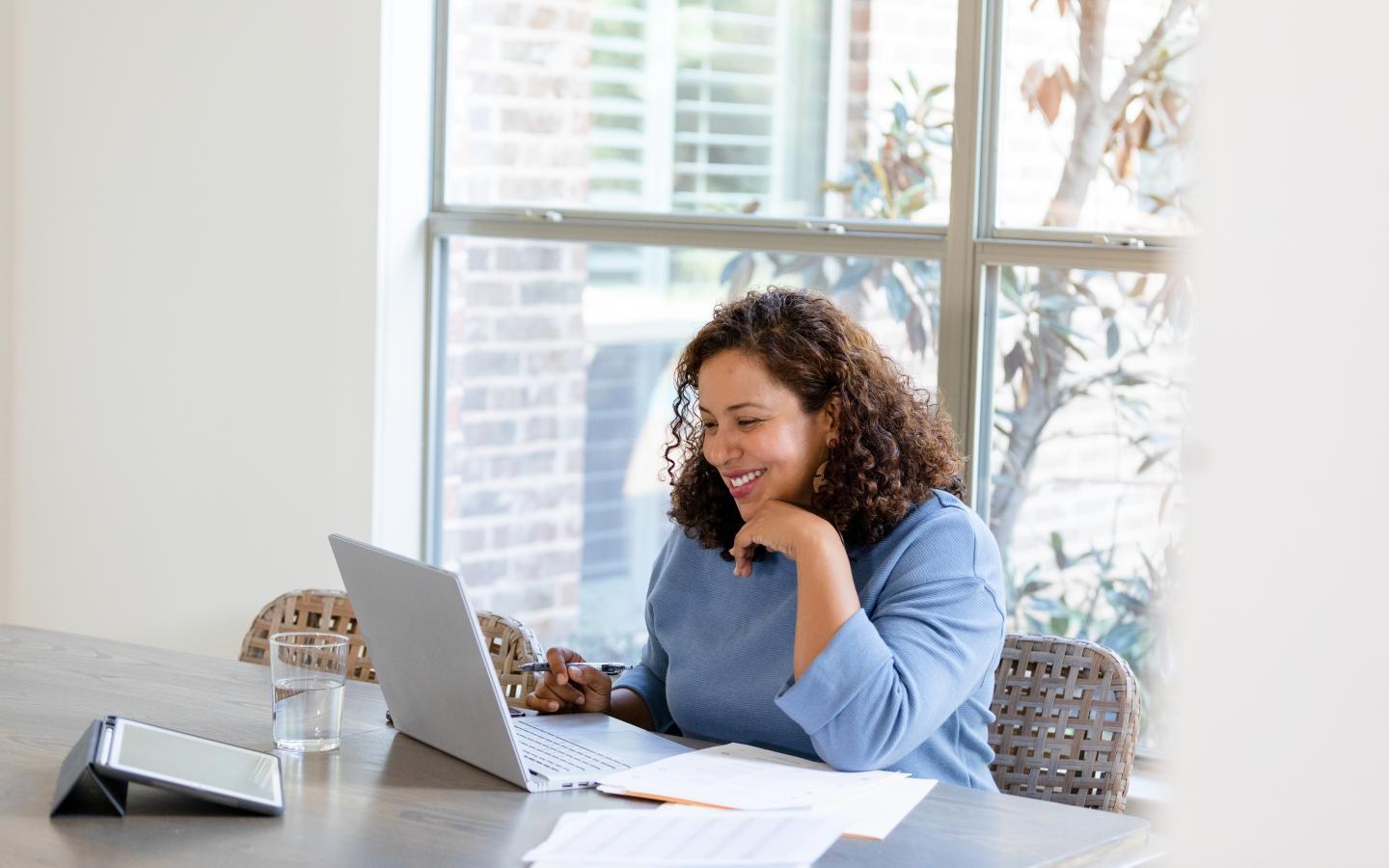 woman sitting at a laptop at a table