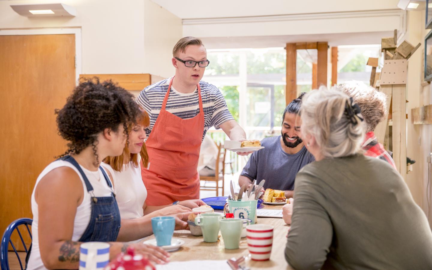 man with a disability serving customers at a cafe