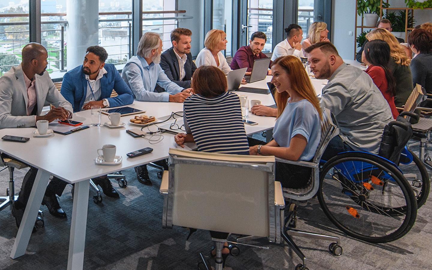 Office workers sitting at a conference table.