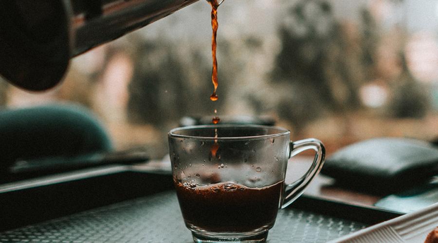 cup with coffee being poured into it to illustrate the idea of getting back to work