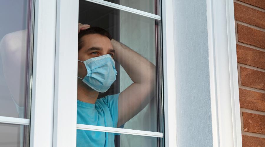 man in mask in quarantine at home