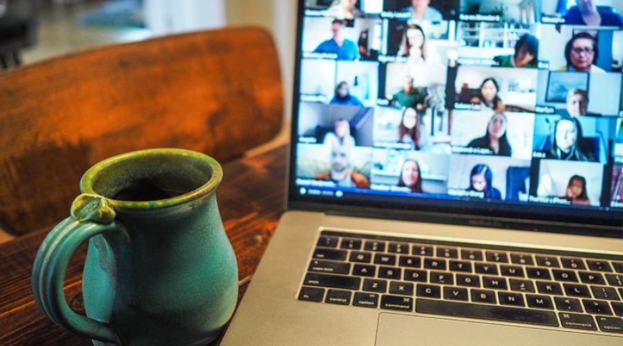 An open laptop showing a zoom meeting window with multiple participants