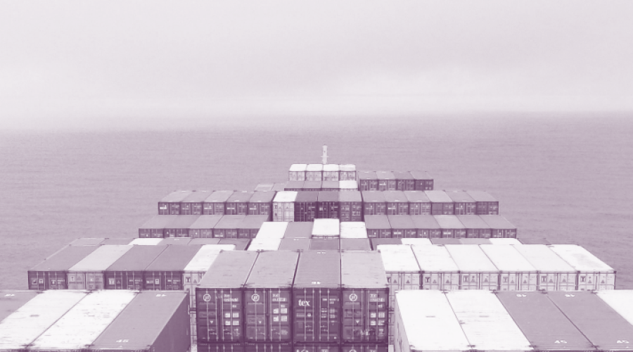 Cargo ship in the ocean with several containers.