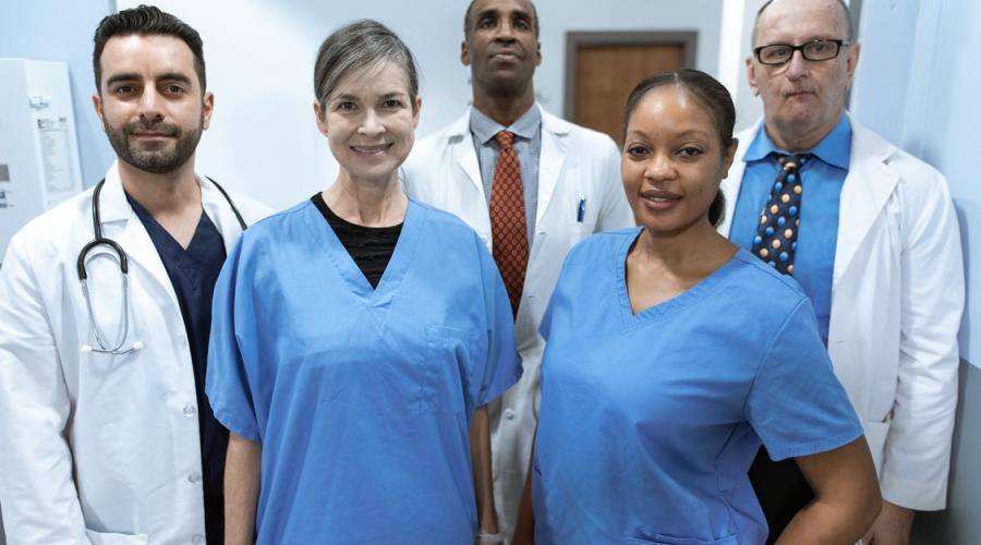 A group of nurses and doctors poses for a photo.