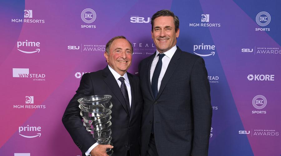 Gary Bettman holding a trophy, standing next to John Hamm. Photo courtesy of Marc Bryan-Brown