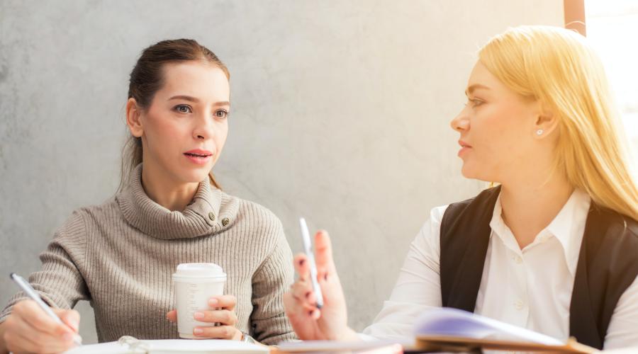 Two women talking at a table