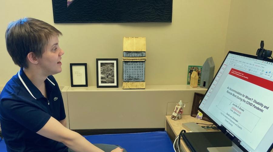 Jennifer Brooks sits in her office while viewing the title page of her award-winning paper on her computer screen.