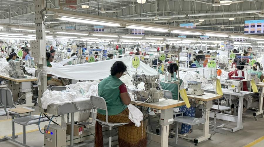 Busy factory floor with rows of sewing stations