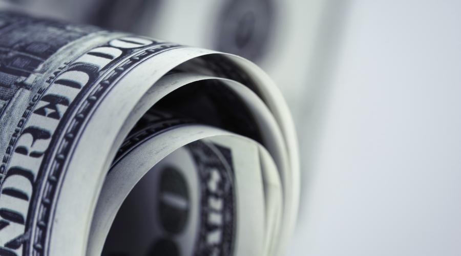 loosely rolled US$100 bills, photo from freepik.com