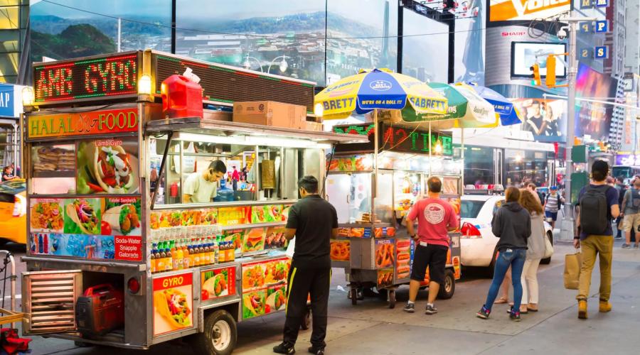 People standing in front of food carts