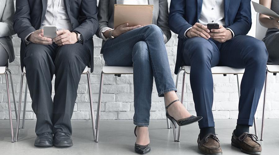 Men and women wait for a job interview