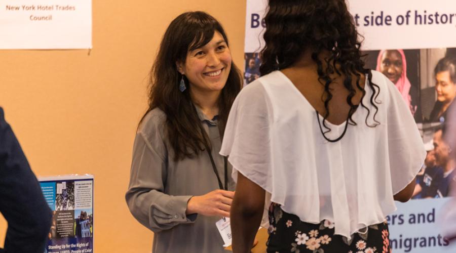 An ILR student speaks with a representative fo the New York Hotel Trades Council at the 2019 Social Justice Career Fair.