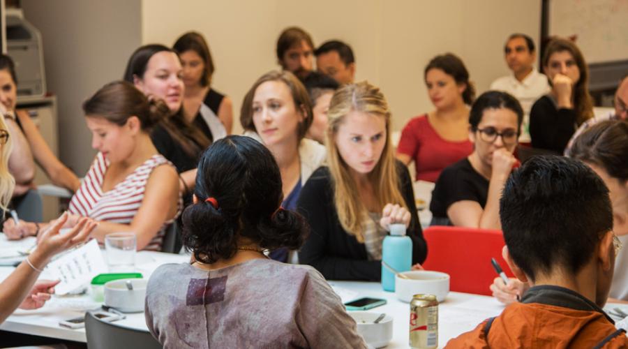 Photo: a group of students in a room at tables