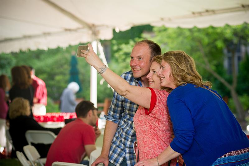 Alumni take a selfie while visiting reunion