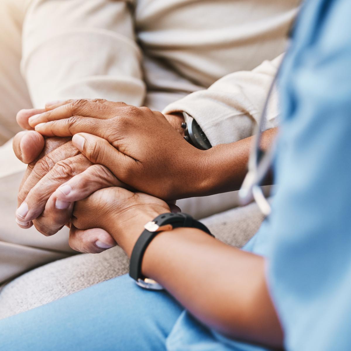 Nurse holding patient's hands