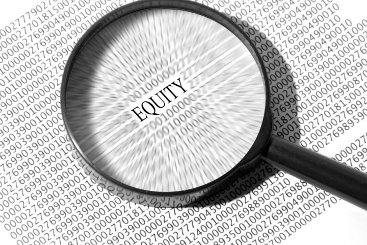A magnifying glass placed over the word equity