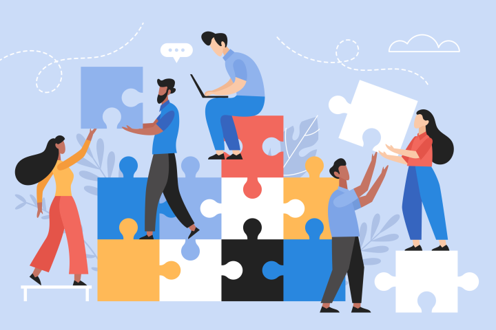 A team of workers assemble puzzle pieces