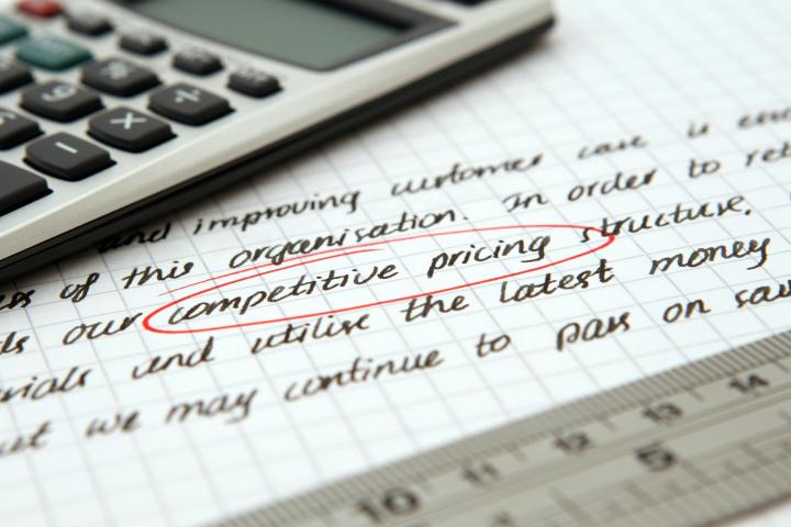 handwritten text with business calculator and "competitive pricing" circled 