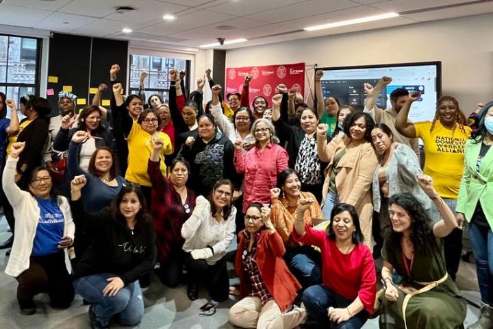 Group of We Rise training participants raising fists in the air