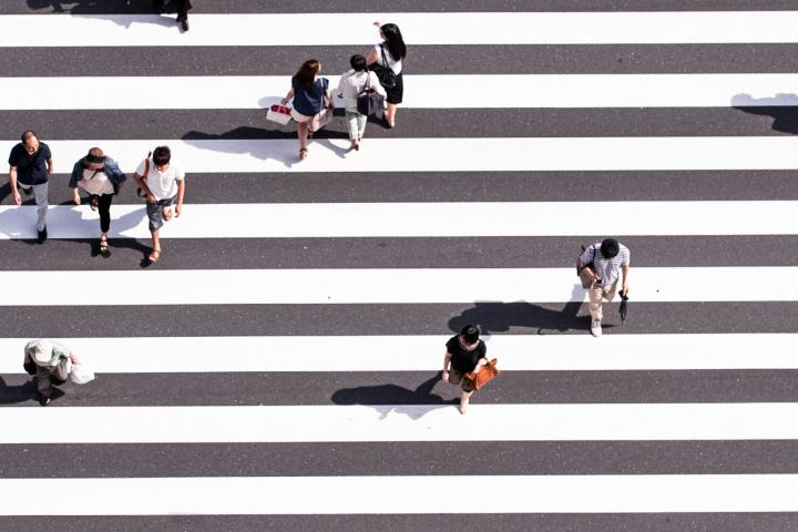 Birds' eye view of people crossing in a crosswalk.