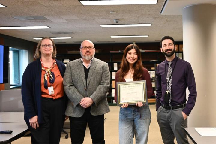 Celine Chauviere ’25 (second from right) receives the Kheel Undergraduate Research Award from librarians and curators (left to right) Haven Hawley, Jim DelRosso, and Steven Calco at an April 9 awarding event. 