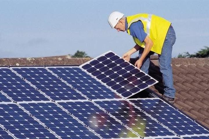 Solar worker installing panels