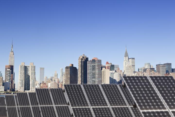 NYC skyline with solar panels on bottom half of image