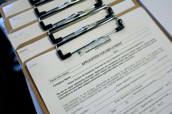 A blank job application form on a clipboard.