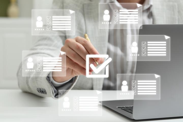 Close up of person putting check mark on virtual screen with icons