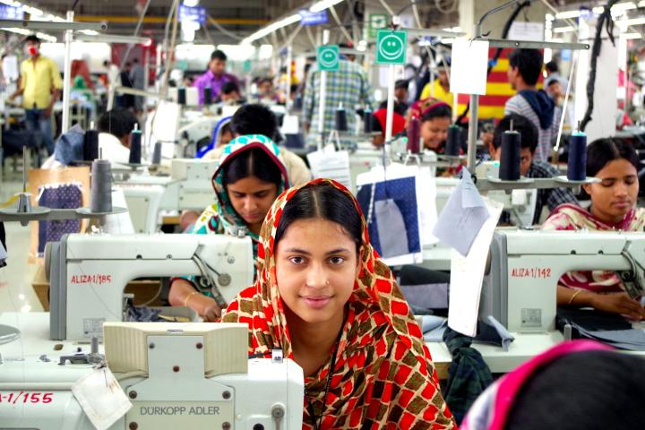Photograph of garment workers in Bangladesh at sewing machines.