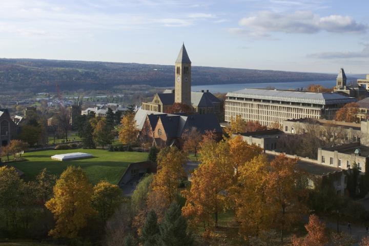 Clock tower on campus with Cayuga Lake behind it