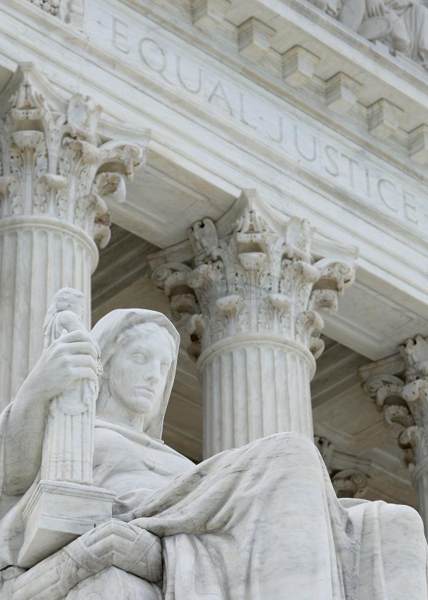 The statue Contemplation of Justice by sculptor James Earle Fraser stands on the steps of the U.S. Supreme Court.